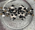 Cow Print Bow Wrap Decal - black and white cow print bow on checkered and gold beaded band wrap