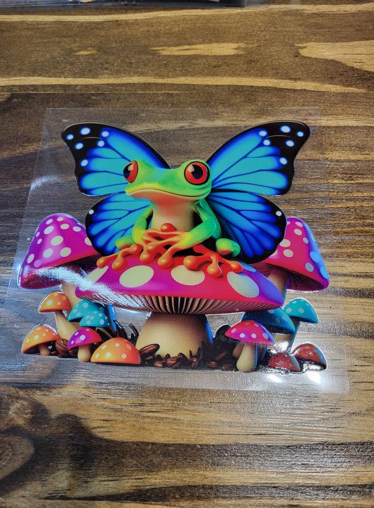 Butterfly Wing Frog on Rainbow Mushrooms Decal - vibrant green tree frog with blue butterfly wings perched on colorful polka dot mushroom cluster