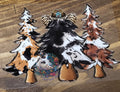 Western Cowhide Christmas Trees - three Christmas trees in tan black and white and brown cowhide prints with center tree topped with leopard bow and turquoise brooch