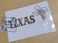 From Texas Decal - gold TEXAS lettering with Texas state outline and wildflower bouquet