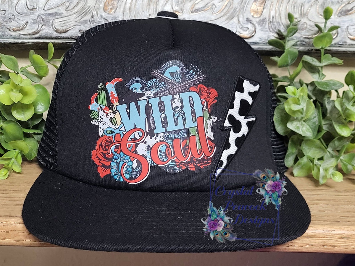 Wild Soul Trucker Hat in Black with boho western graphic and cow print lightning bolt patch
