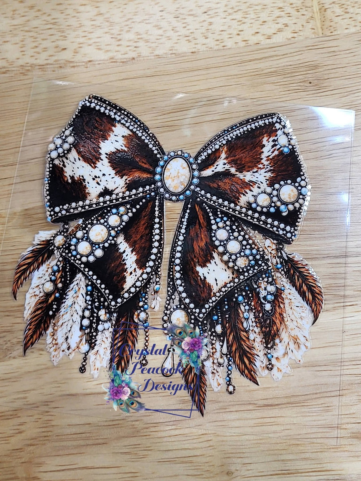 Cowhide Feather and Rhinestone Bow - brown and white cowhide print bow with turquoise stones pearl and rhinestone detailing and cascading feathers with dangling chain accents