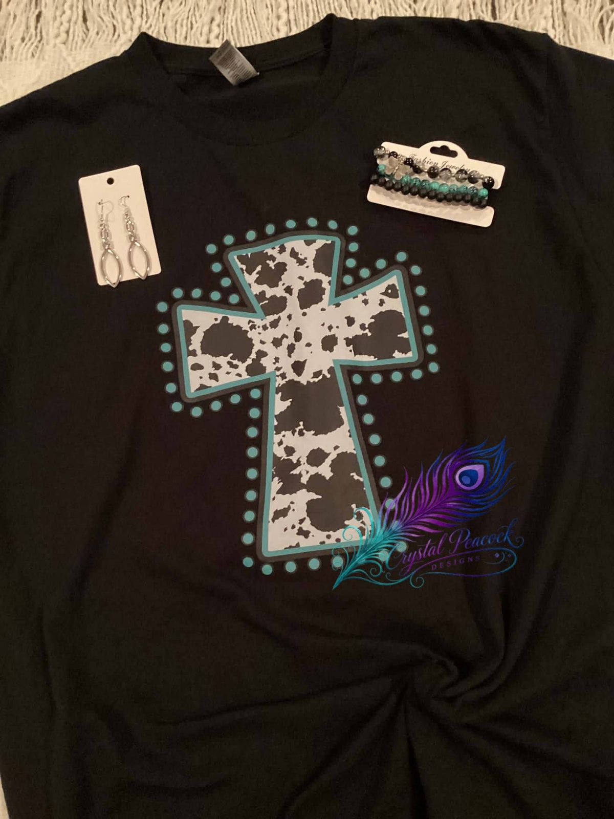 Cow print cross with turquoise detail graphic tee