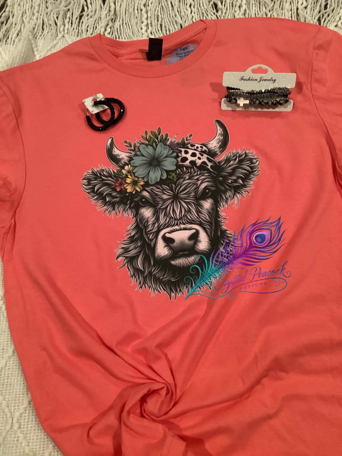 Highland cow with floral crown graphic tee on coral shirt