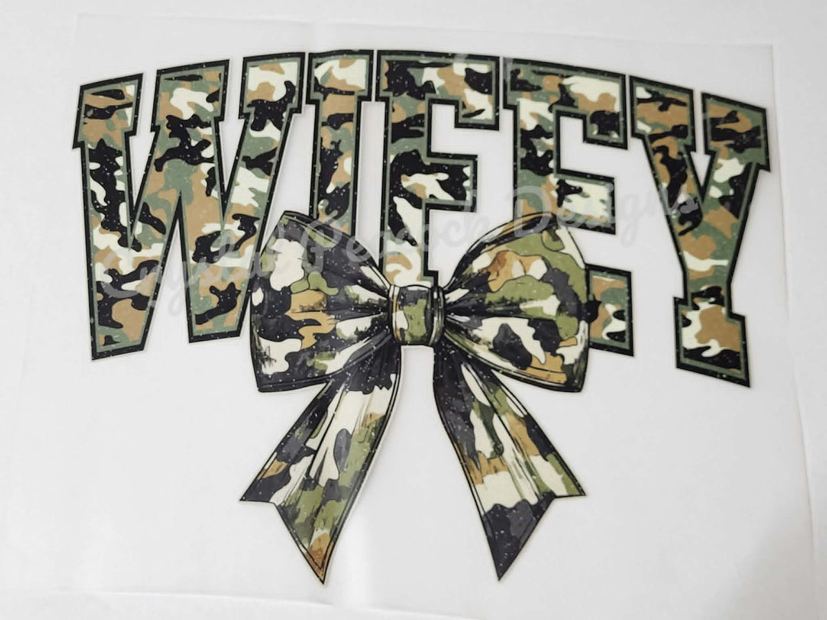Wifey camo bow shirt decal with arched varsity lettering in green camo print and matching camo bow